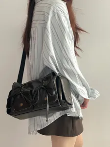 Black multi-pocket shoulder bag with cute bow drawstring details, stylish Y2K fashion accessory.