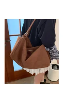 Detail view of the casual brown suede shoulder underarm pillow bag showing soft texture.