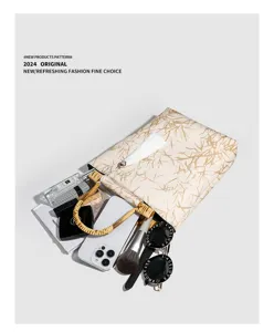 Detailed view of a retro Chinese style bamboo handle tote bag with delicate tassel and leaf print.