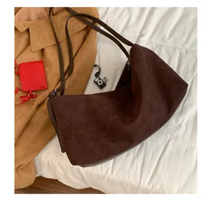 Brown suede shoulder bag for women, minimalist large capacity underarm hobo pillow bag style.