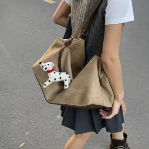 Korean style casual large capacity underarm shoulder bag with cute puppy plush pendant.