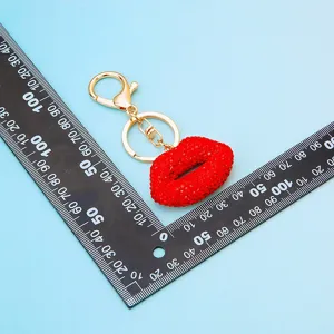 Rhinestone red lips keychain detail shot, showing metal ring and sparkling crystal texture.
