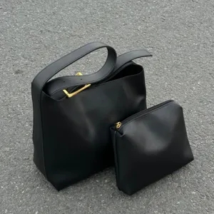 Black minimalist slouchy shoulder bag and pouch set, chic casual daily handbag detail.