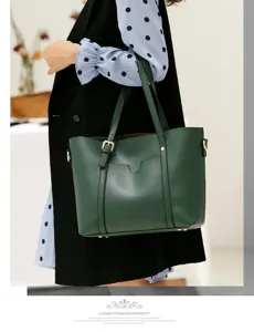Detailed view of the dark green leather tote bag with elegant metallic buckle and spacious design.