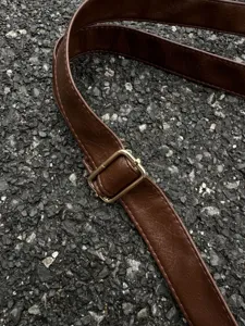 Brown leather shoulder bag replacement strap with gold metal buckle, stylish bag accessory detail.