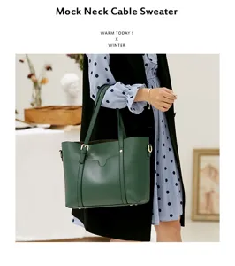 Detailed view of the dark green faux leather tote bag showing its sleek structure and metal buckle.