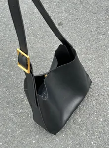 Black PU leather shoulder bucket bag detail, casual minimalist daily tote purse with gold buckle.