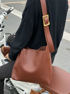 Casual brown slouchy bucket shoulder bag with matching pouch for women daily commute use.