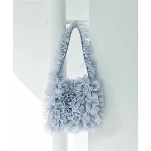 Close-up detail view of light blue mesh ruffled shoulder tote bag texture and design.
