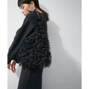 Close-up detail of the black tulle ruffled shoulder bag showcasing unique design and texture.