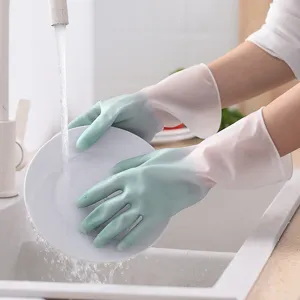 Detail view of gradient waterproof dishwashing gloves worn during kitchen sink cleaning tasks.