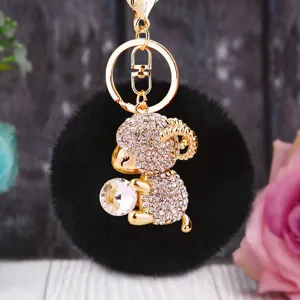 Cute rhinestone ram plush keychain with fluffy black pom pom and metal ring for bag.