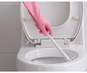 Detail shot of pink rubber household cleaning gloves in use, featuring non-slip texture.