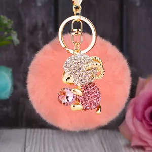 Cute fluffy pom pom sheep keychain with sparkling rhinestones and pink crystal gem pendant.