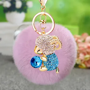Cute plush pom pom keychain with rhinestone sheep and blue crystal ball for women and bags.