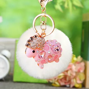 Fluffy plush sheep keychain detail view, sparkling rhinestone pink sheep pendant with gold keyring.