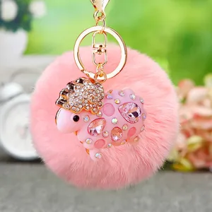 Cute pink rhinestone sheep plush pom-pom keychain bag charm with gold metal keyring detail view