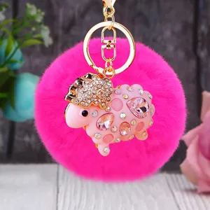 Detailed view of the cute rhinestone sheep plush keychain with fluffy pom pom and gold ring.