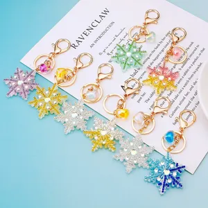 Rhinestone snowflake metal keychains with cute heart charms, sparkling bag pendants for gifts.