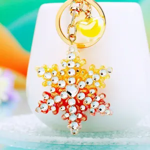 Close-up of the dazzling rhinestone snowflake keychain pendant with sparkling crystal details.