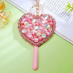 Detailed view of rhinestone heart flower mirror car keychain, cute bag pendant and charm.