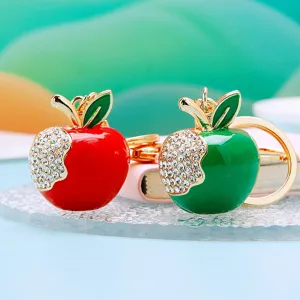 Cute rhinestone apple keychain detail shot, sparkling crystal metal pendant for car keys and bags.