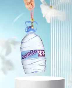 Detailed shot of a pink braided keychain charm lifting a large water bottle, elegant design.