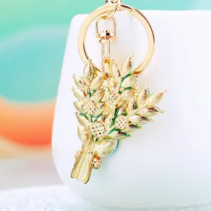 Exquisite gold tone wheat metal keychain and bag charm, elegant detailed accessory gift.