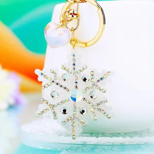 Rhinestone snowflake keychain with sparkling crystal and cute heart charm, elegant metal keyring.