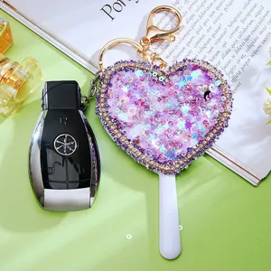 Heart-shaped sequin makeup mirror keychain with car key fob, sparkling rhinestone bag charm.