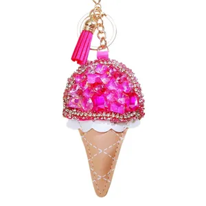 Sparkling rhinestone ice cream cone keychain bag charm with pink leather tassel detail.