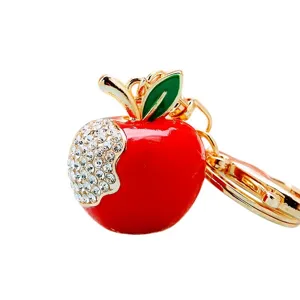 Cute crystal rhinestone apple keychain and bag pendant, gold tone metal half drill design.