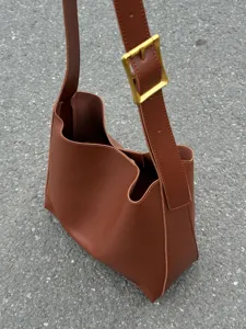 Brown soft leather shoulder bag detail, stylish minimalist hobo handbag for daily casual wear.