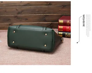 Detailed view showing the reinforced bottom and metal protective feet of the soft leather handbag.