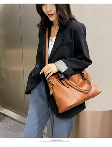 Detail view of the brown leather shoulder bag in a modern outfit scene, stylish and practical.