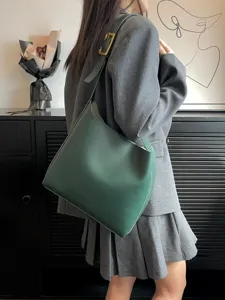 Minimalist green slouchy shoulder bag, casual soft leather bucket handbag for daily wear.