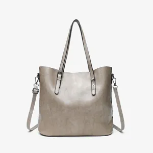 Detailed view of the vintage oil wax leather tote bag with dual handles and metal hardware.