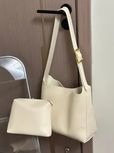 Minimalist beige slouchy shoulder bag set with pouch, detailed view of soft leather and hardware.