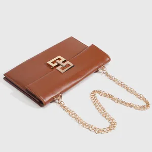 Brown leather crossbody chain bag for women, vintage shoulder bag with metal geometric clasp.