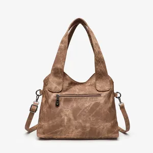 Vintage brown canvas tote shoulder bag, detailed view showing zipper pocket and metal hardware.
