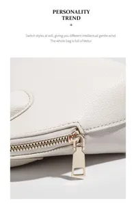 White leather shell bag zipper detail, premium gold metal hardware and fine texture.