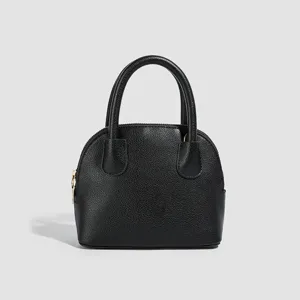 Classic black textured dome handbag with dual top handles and chic minimalist design for daily wear.