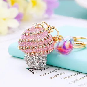 Close-up detail of rhinestone striped mushroom keychain with colorful heart pendant charm.