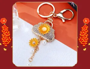 Exquisite sunflower handbag car keychain with rhinestones and pearls, stylish gold metal pendant.