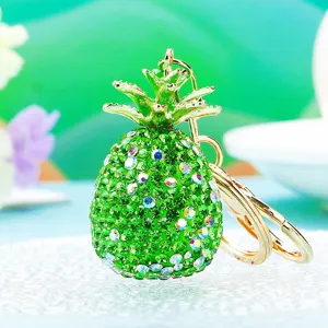 Close up detail shot of a sparkling green crystal rhinestone pineapple metal keychain.