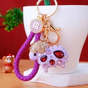 Cute rhinestone sheep keychain with purple braided leather strap and metal ring for women bags.