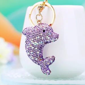 Close-up detail of a sparkling purple rhinestone dolphin keychain pendant hanging securely.