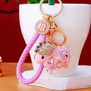 Detailed close-up view of the cute pink sheep keychain adorned with glittering rhinestones and strap.