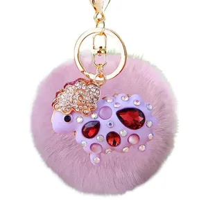Fluffy purple rhinestone sheep keychain with gold metal ring, cute bag charm and car key accessory.