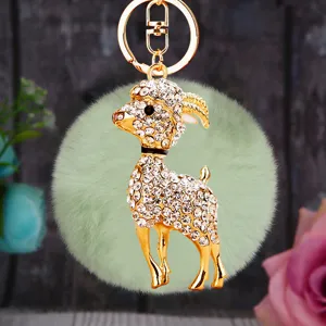 Rhinestone crystal encrusted goat keychain detail, cute fluffy green plush pom pom bag charm